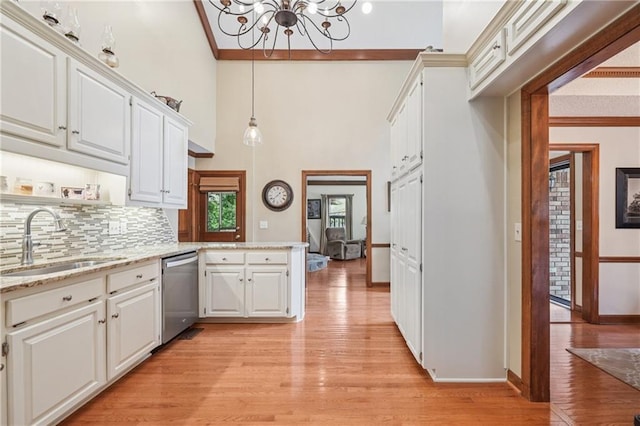2011 Sturbridge Ln, Buford, GA 30519 - kitchen featuring dishwasher, a chandelier, a sink, light wood-style floors, and a high ceiling