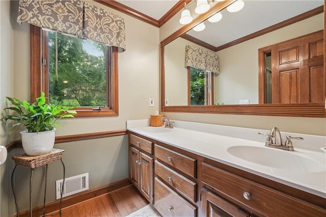 2011 Sturbridge Ln, Buford, GA 30519 - bathroom featuring double vanity, wood finished floors, crown molding, and baseboards