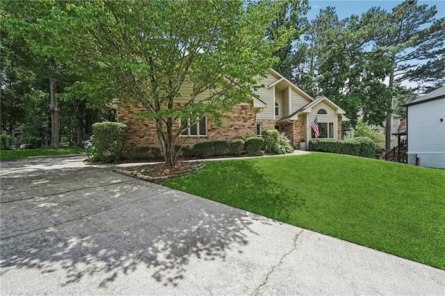 2011 Sturbridge Ln, Buford, GA 30519 - view of property hidden behind natural elements with brick siding and a front lawn