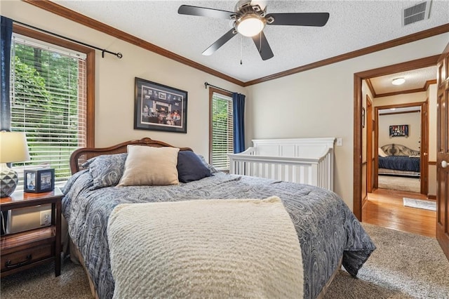 2011 Sturbridge Ln, Buford, GA 30519 - carpeted bedroom featuring ornamental molding, a textured ceiling, and a ceiling fan