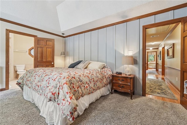2011 Sturbridge Ln, Buford, GA 30519 - carpeted bedroom with vaulted ceiling, crown molding, a decorative wall, and ensuite bathroom