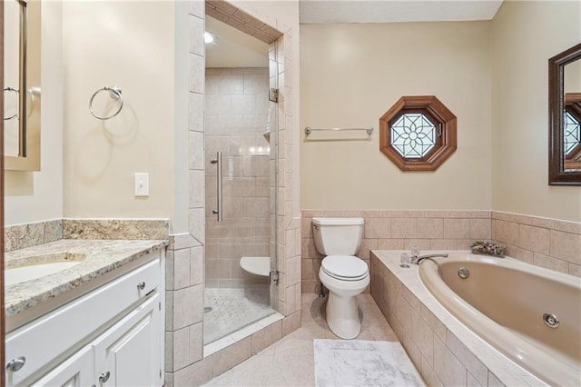2011 Sturbridge Ln, Buford, GA 30519 - bathroom with toilet, vanity, a garden tub, a shower stall, and tile patterned floors