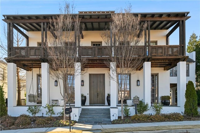 view of front of house featuring a balcony