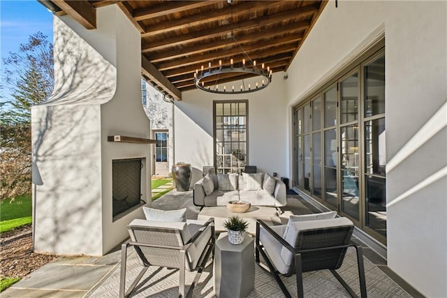 view of patio featuring an outdoor living space with a fireplace