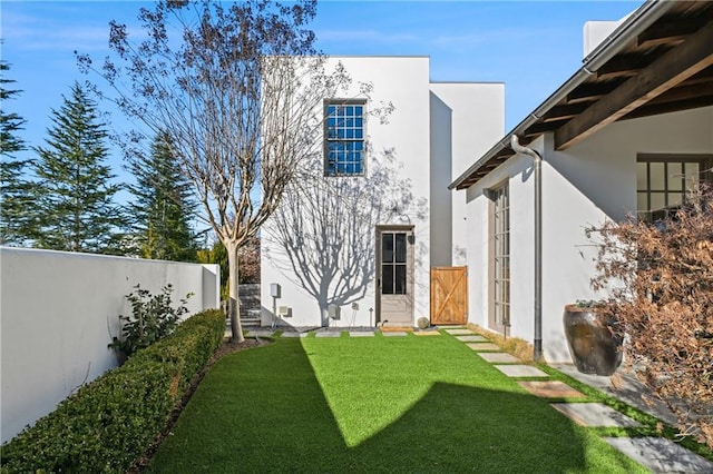 rear view of house featuring a yard