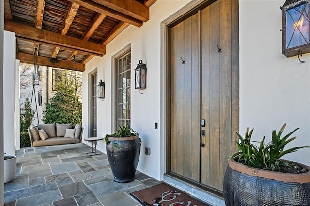 view of exterior entry with covered porch