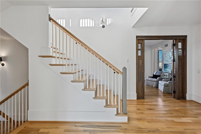 staircase featuring wood-type flooring