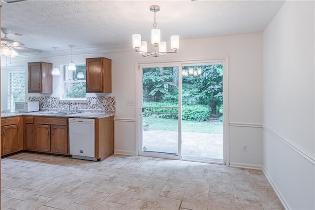 4307 Windward Ln, Norcross, GA 30093 - kitchen with white appliances, brown cabinets, a chandelier, healthy amount of natural light, and a textured ceiling