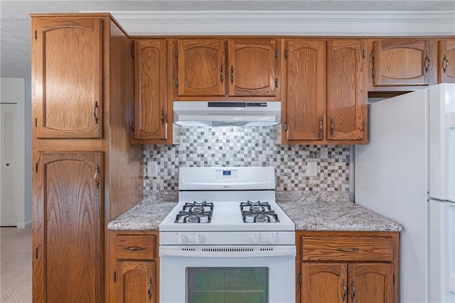 4307 Windward Ln, Norcross, GA 30093 - kitchen with white appliances, under cabinet range hood, brown cabinetry, and decorative backsplash