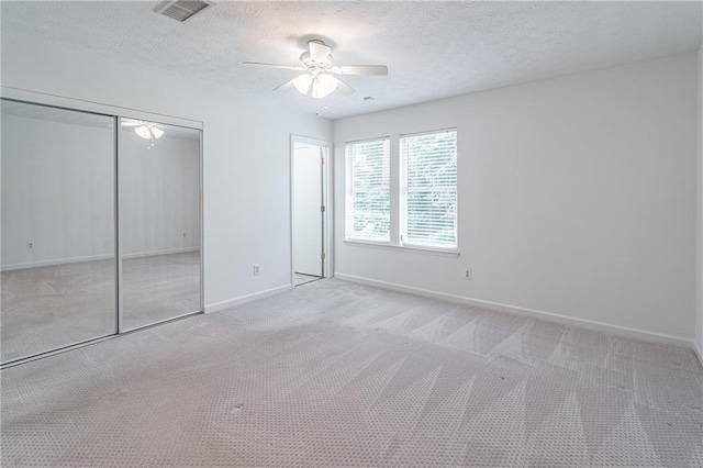 4307 Windward Ln, Norcross, GA 30093 - unfurnished bedroom featuring carpet flooring, a closet, a textured ceiling, and a ceiling fan