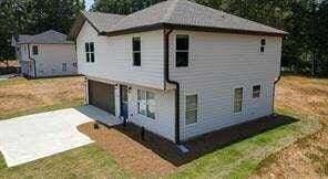 exterior space with a garage and a yard