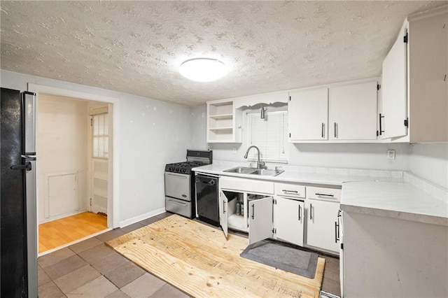 kitchen with white cabinets, black appliances, wood-type flooring, and sink