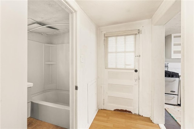 bathroom featuring wood-type flooring and bathtub / shower combination