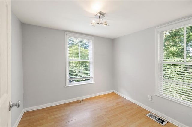 unfurnished room featuring light hardwood / wood-style flooring