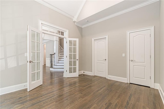 spare room featuring french doors, crown molding, dark hardwood / wood-style flooring, and high vaulted ceiling