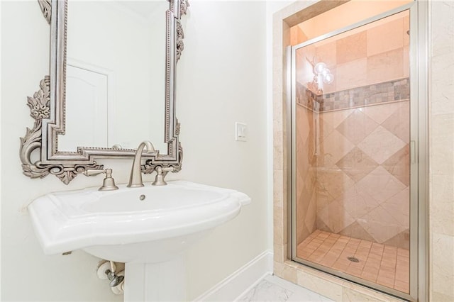 bathroom featuring sink and a shower with shower door