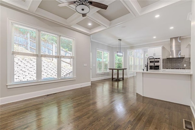 unfurnished living room with dark hardwood / wood-style flooring, crown molding, beam ceiling, and coffered ceiling