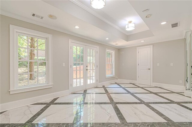 doorway featuring ornamental molding, french doors, and a raised ceiling