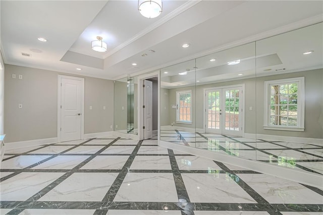 unfurnished room featuring crown molding, a tray ceiling, and french doors