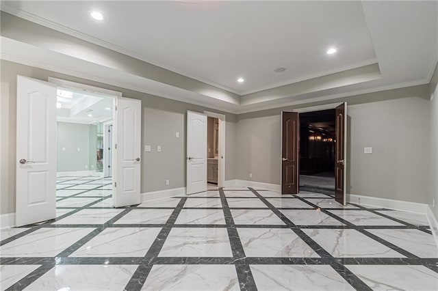 unfurnished room with crown molding and a tray ceiling