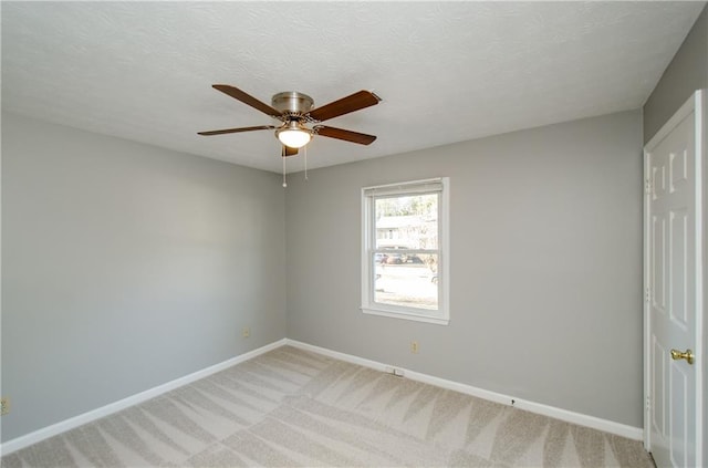 empty room with light carpet and ceiling fan