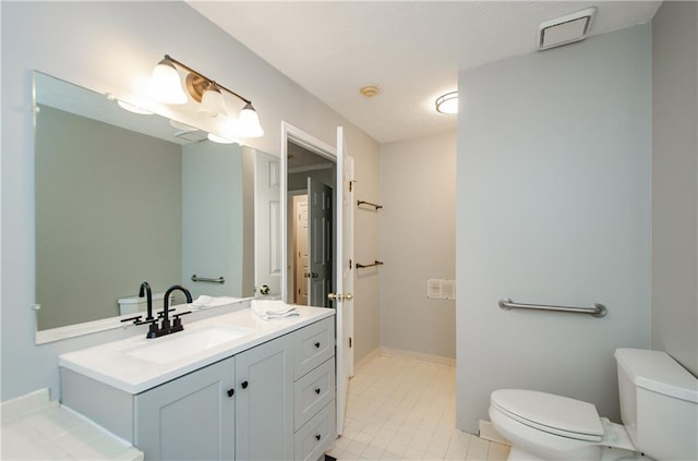 bathroom featuring toilet and vanity