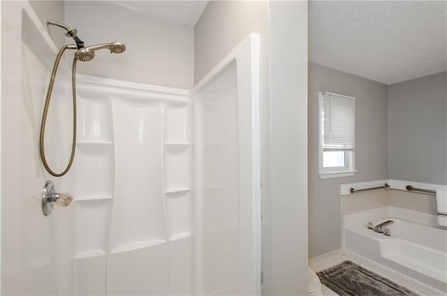 bathroom with a textured ceiling and plus walk in shower