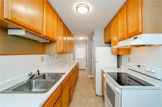 kitchen with white appliances, a textured ceiling, and sink