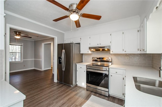 kitchen featuring appliances with stainless steel finishes, white cabinetry, crown molding, and tasteful backsplash