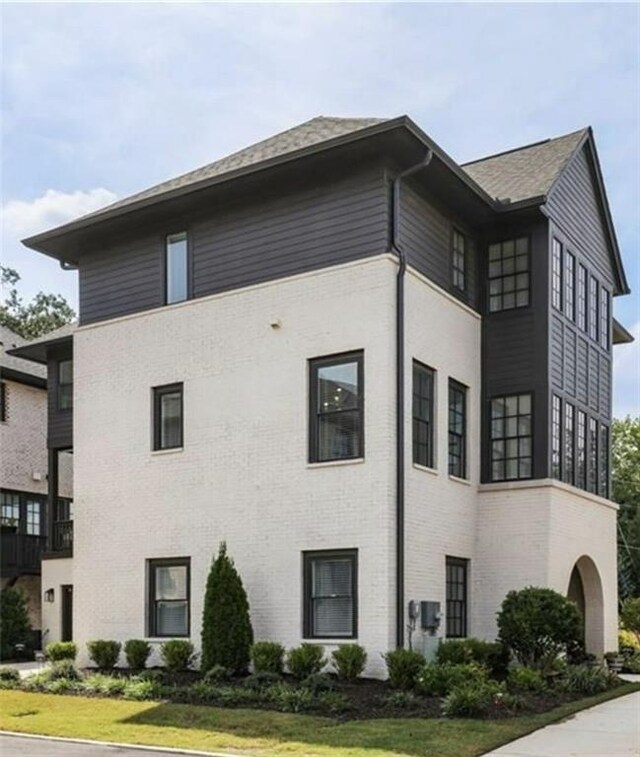6626 Sterling Dr, Sandy Springs, GA 30328 - view of side of home featuring a yard, brick siding, and roof with shingles