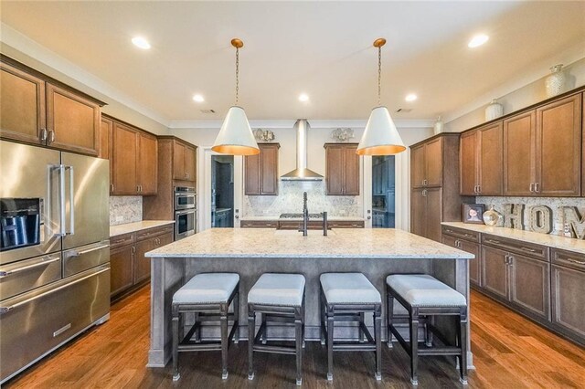 6626 Sterling Dr, Sandy Springs, GA 30328 - kitchen with appliances with stainless steel finishes, wall chimney range hood, backsplash, crown molding, and recessed lighting