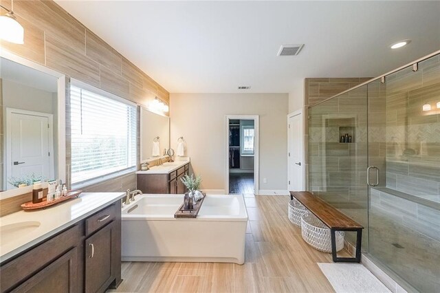 6626 Sterling Dr, Sandy Springs, GA 30328 - full bathroom featuring plenty of natural light, a shower stall, a bathtub, and two vanities