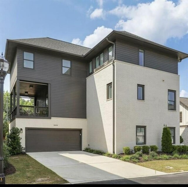 6626 Sterling Dr, Sandy Springs, GA 30328 - rear view of house featuring concrete driveway and an attached garage