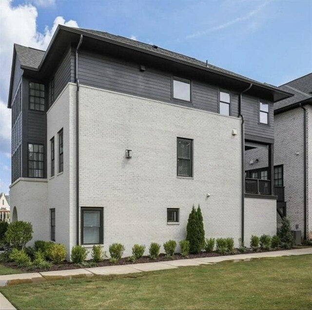 6626 Sterling Dr, Sandy Springs, GA 30328 - view of side of property featuring a lawn, brick siding, and central AC