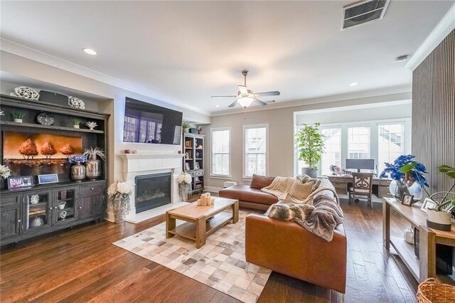 6626 Sterling Dr, Sandy Springs, GA 30328 - living area with wood-type flooring, a fireplace with raised hearth, ornamental molding, ceiling fan, and recessed lighting