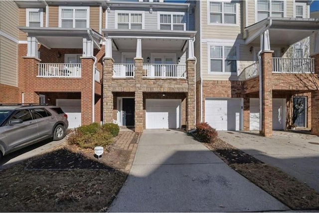 view of property featuring an attached garage and driveway