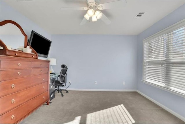 carpeted home office with visible vents, ceiling fan, and baseboards