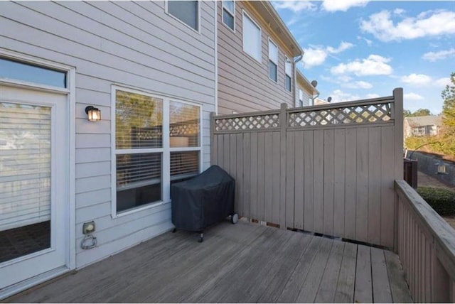 wooden terrace with a grill