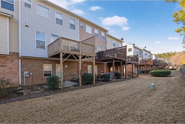 rear view of property featuring brick siding and a residential view