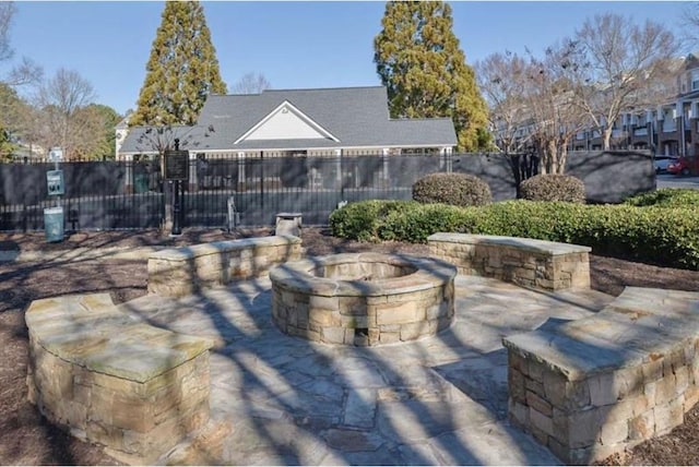 view of patio / terrace featuring a fire pit and fence