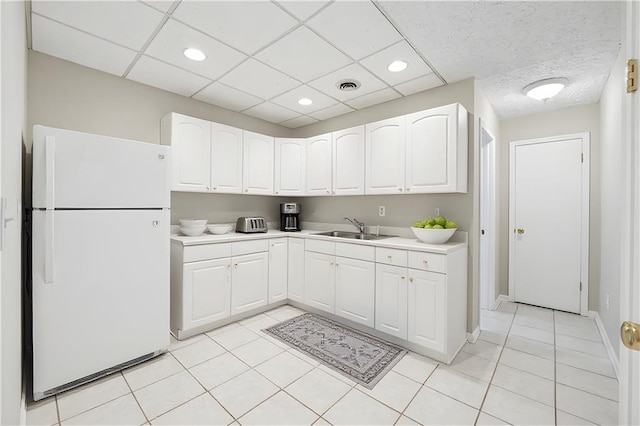 2655 Nesbit Trl, Alpharetta, GA 30022 - kitchen featuring freestanding refrigerator, light tile patterned floors, white cabinetry, light countertops, and recessed lighting