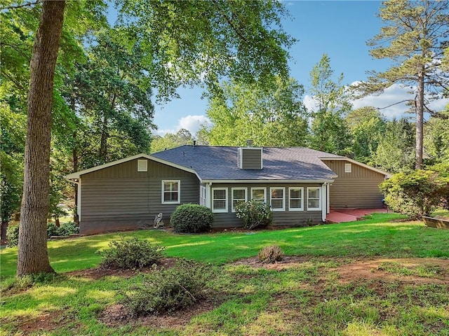 2655 Nesbit Trl, Alpharetta, GA 30022 - back of property featuring a lawn, a chimney, and roof with shingles