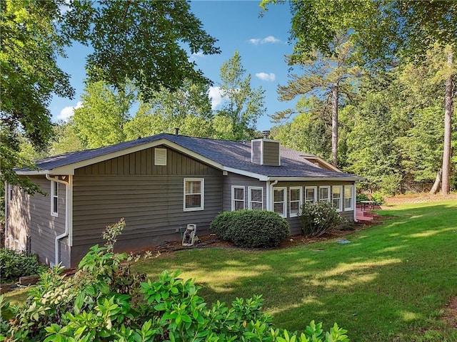 2655 Nesbit Trl, Alpharetta, GA 30022 - view of property exterior with a lawn, a chimney, and roof with shingles