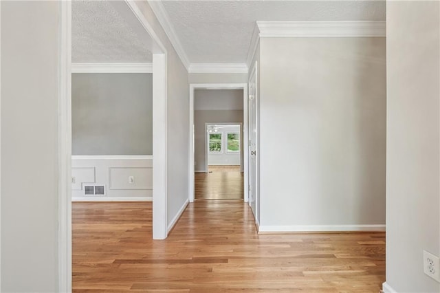 2655 Nesbit Trl, Alpharetta, GA 30022 - hall featuring wood finished floors, crown molding, and a textured ceiling
