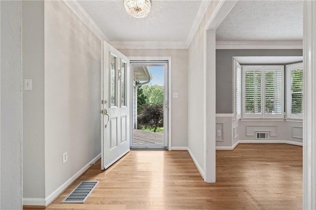 2655 Nesbit Trl, Alpharetta, GA 30022 - entrance foyer featuring light wood-type flooring, crown molding, and a chandelier