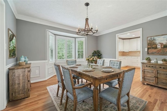 2655 Nesbit Trl, Alpharetta, GA 30022 - dining space featuring a chandelier, light wood-type flooring, ornamental molding, and a textured ceiling