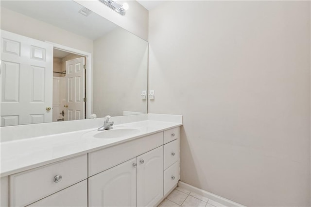 bathroom featuring tile patterned floors, baseboards, and vanity