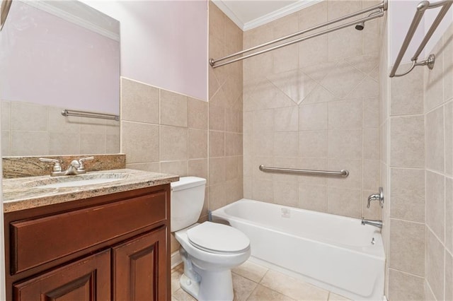 bathroom with tub / shower combination, toilet, vanity, tile patterned floors, and tile walls