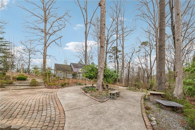 surrounding community featuring driveway and fence