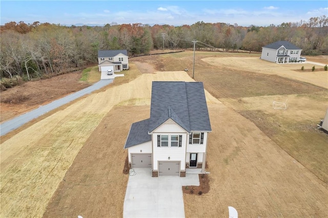 birds eye view of property with a view of trees